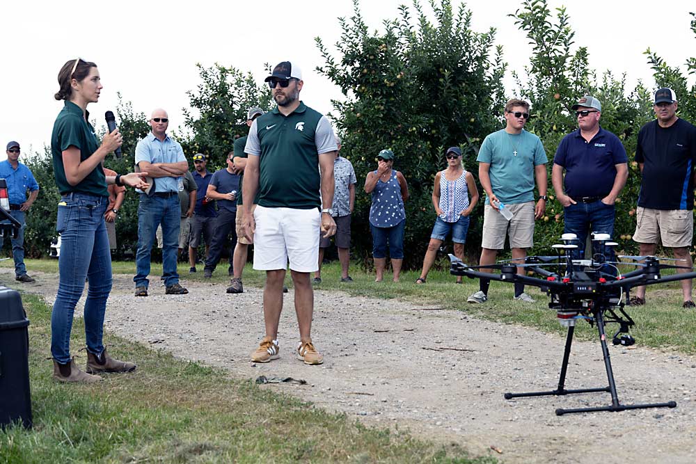 MSU’s Anna Wallis, left, and Richard Price discuss drones and aerial imagery of orchards during the Michigan Pomesters 10th annual RidgeFest on July 29. (Matt Milkovich/Good Fruit Grower)