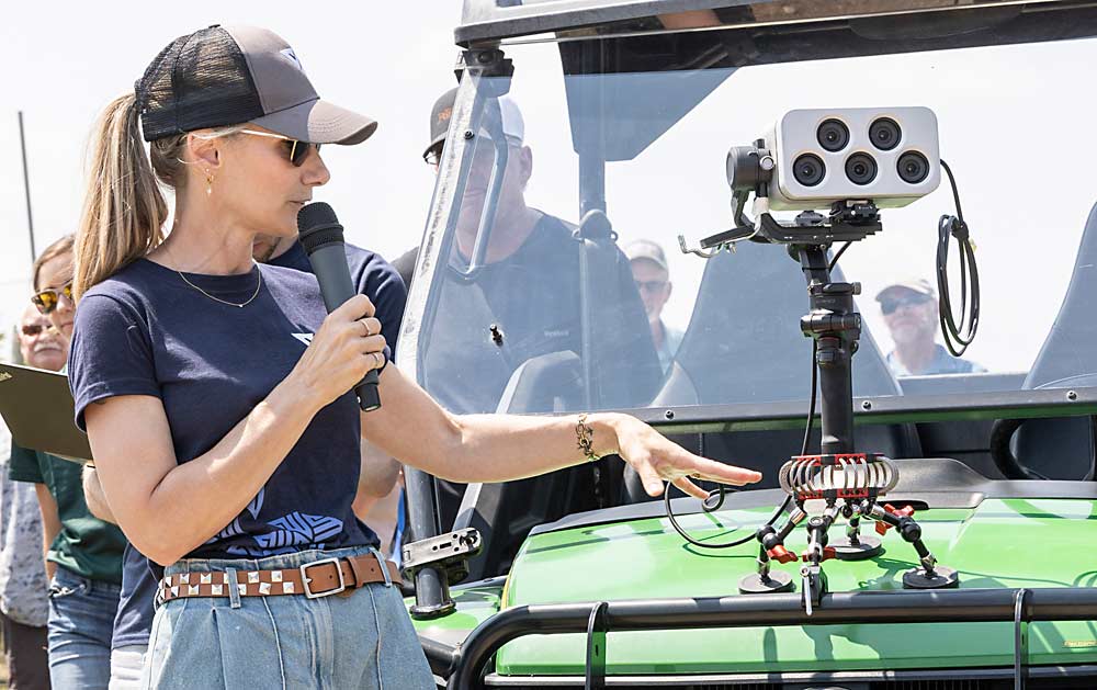 Vivid Machines CEO Jenny Lemieux displays her company’s X-Vision camera mounted on an ATV at the RidgeFest grower tour near Sparta, Michigan, in July. The camera captures images as it’s driven through the row, and the data can be viewed in real time via a mobile device. (Matt Milkovich/Good Fruit Grower)