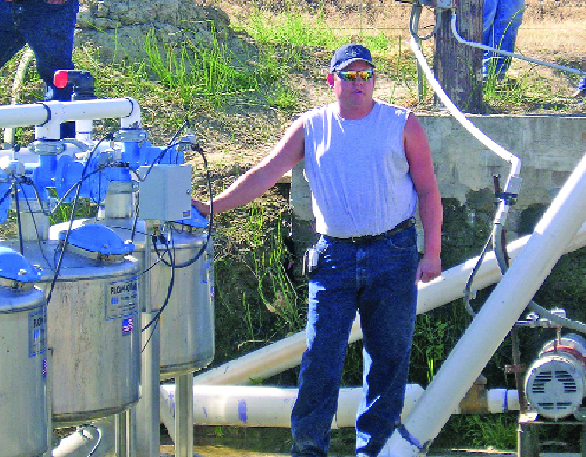 John Neimeyer of Airport Ranches talks about the pump controlling the newly installed drip irrigation system at the ­Outlook vineyard. Photo by Anne Sampson