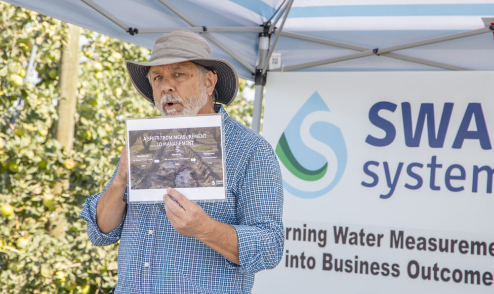 Val King of Swan Systems discusses irrigation and nutrient management software at the field day. (Ross Courtney/Good Fruit Grower)