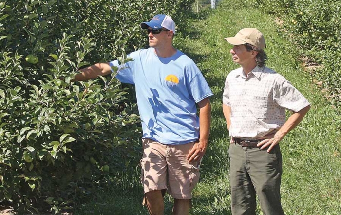 Randy Beaudry outlined the storage protocols he has developed for maintaining Honeycrisp quality. He spoke to growers in orchard operated by Joe, Al, Dan, and Ryan Dietrich near Conklin, Michigan. He and Dan look over the developing Honeycrisp crop. (Richard Lehnert/Good Fruit Grower)