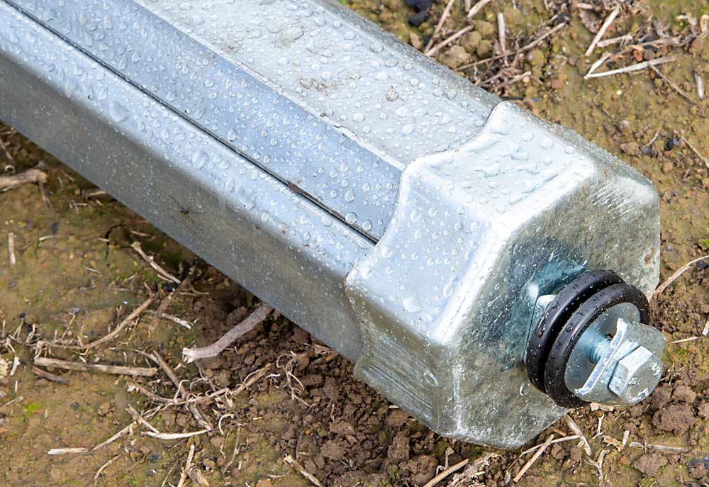 De Kleine and his suppliers designed end caps for the octagonal posts in the Benton City orchard. The nut on the end will hold crisscrossed steel cables, while the two black washers will hold rain-protection material. (Ross Courtney/Good Fruit Grower)