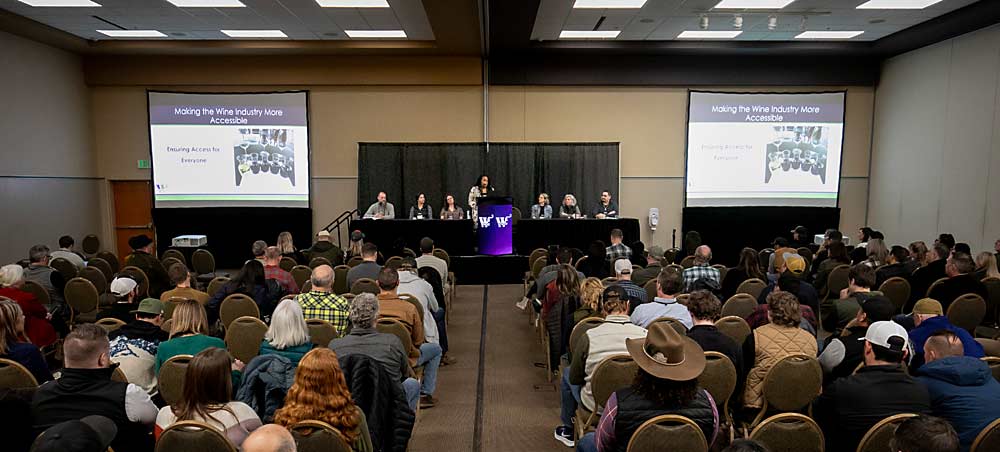 A full room gathered to kick off WineVit, the annual convention and trade show organized by the Washington Winegrowers Association in Kennewick, Washington, on Feb. 5 for a conversation about welcoming a diverse next generation to the wine industry. The discussion included, from left, Todd Newhouse, Devyani Gupta, Sadie Drury, moderator Lakaya Renfrow at the podium, Ashley Trout, Rosanna Lugo and Victor Palencia. (TJ Mullinax/Good Fruit Grower)
