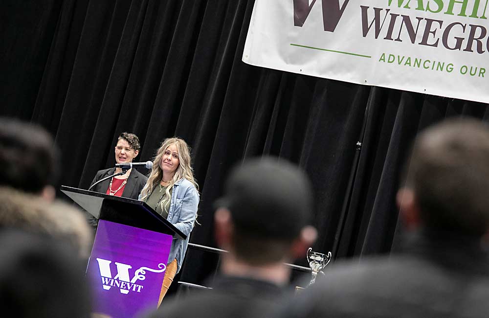 Carly Faulk, vineyard manager for Four Feathers, smiles at her family as she accepts the surprise honor of the Erick Hanson Memorial Grower of the Year Award at WineVit on Feb. 5. (TJ Mullinax/Good Fruit Grower)