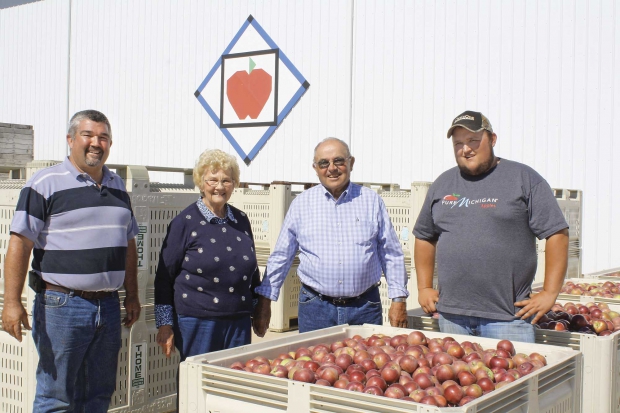 The Thome family poses for a portrait. The new building in the background will house CA storage rooms next year. From left are Steve, JoAnn, Harold, and Mitch. (Richard Lehnert/Good Fruit Grower)