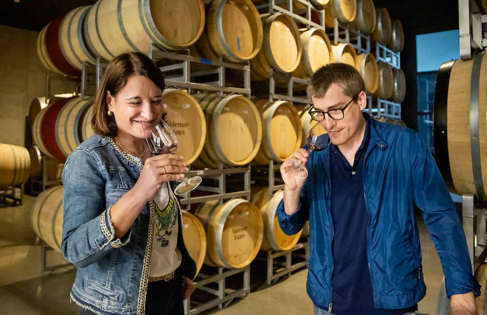 Fifth-generation wine producers Ana Martínez Bujanda and her brother, Jesús Martínez Bujanda, taste from a barrel of 2022 Cabernet Sauvignon at Valdemar Estates in Walla Walla, Washington, the newest location for Valdemar Family, the name of their wine company based in Spain. (Ross Courtney/Good Fruit Grower)