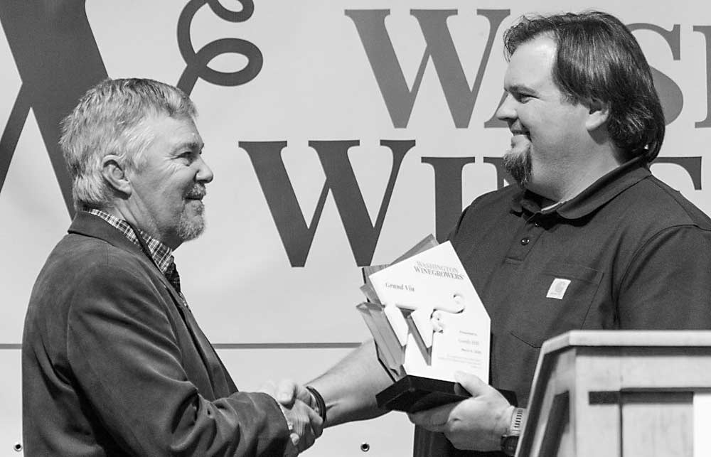 Gordon “Gordy” Hill, left, receives the 2019 Grand Vin award from Shane Collins. (TJ Mullinax/Good Fruit Grower)