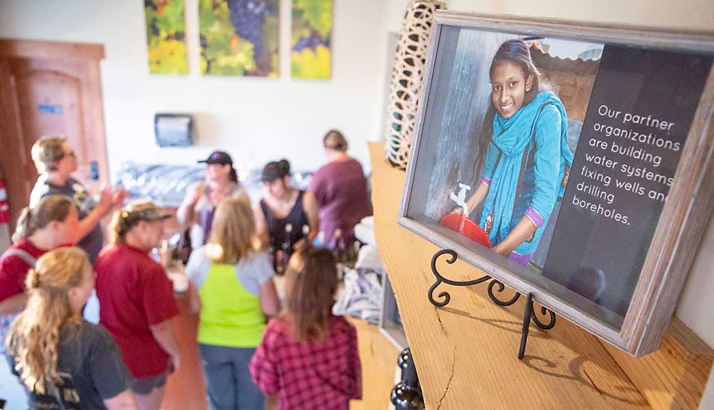 Following an afternoon of picking, volunteers gather to taste — and purchase — wine in the tasting room, decorated in homage to the cause. (Ross Courtney/Good Fruit Grower)