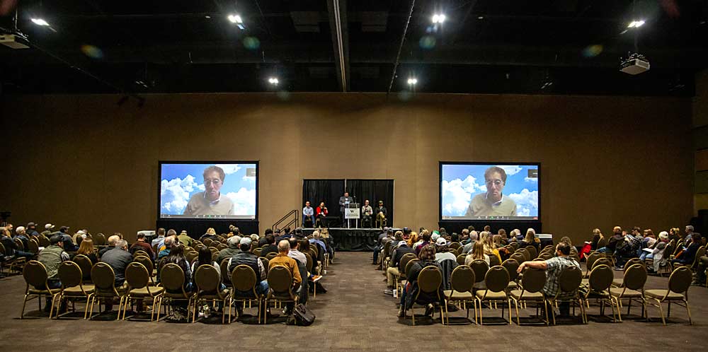 A panel fields questions regarding the state of the Washington wine grape industry in February at the annual WineVit conference at the Three Rivers Convention Center in Kennewick, Washington. On the screens is Cliff Mass, University of Washington professor of atmospheric sciences, who presented by video conference. (Ross Courtney/Good Fruit Grower)