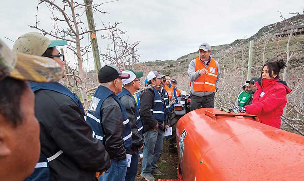 Ofelio Borges, Washington State Department of Agriculture, talks during a spray application training in Naches, Washington, held in March 2016 to help orchard workers improve results. (TJ Mullinax/Good Fruit Grower)