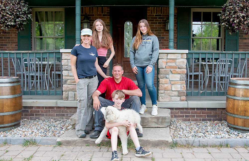 The Youngblood family on the front porch at Youngblood Vineyard. Clockwise from left: Jessica, Gracie, Georgia, David, Wyatt and one of their new puppies. (Matt Milkovich/Good Fruit Grower)