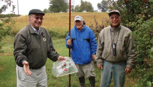 Midwest Apple Improvement Association founders Ed Fackler (left) and Mitch Lynd (right) met in Jim Eckert’s MAIA planting to help with apple evaluation, a process that has members tasting thousands of fruit each fall. Photo courtesy of Diane Doud Miller