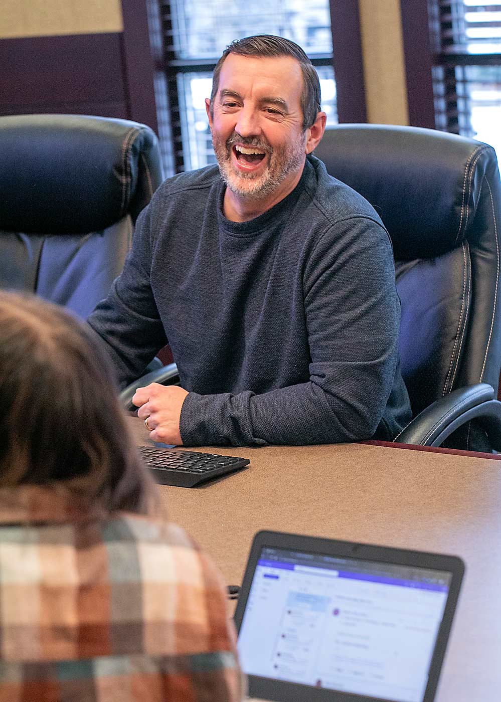 Clint Novak, chief financial officer at Allan Bros., laughs with student interns as they consider how to prioritize their finances in personal budgets. (TJ Mullinax/Good Fruit Grower)