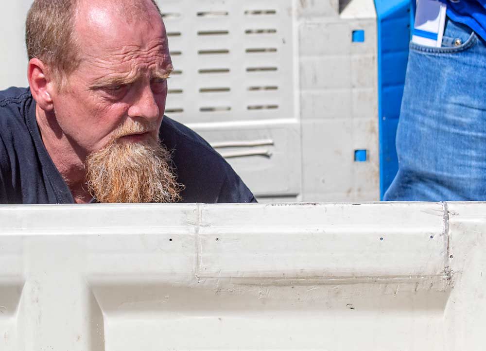 Brian Bennett of Meduri Farms in Salem, Oregon, checks out a more complex bin repair, where an entire segment of the bin was replaced with a piece from another bin. (TJ Mullinax/Good Fruit Grower)