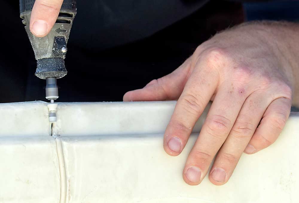 Before welding a bin, rough up cracks and broken areas with a grinder or sandpaper for better adherence. (TJ Mullinax/Good Fruit Grower)