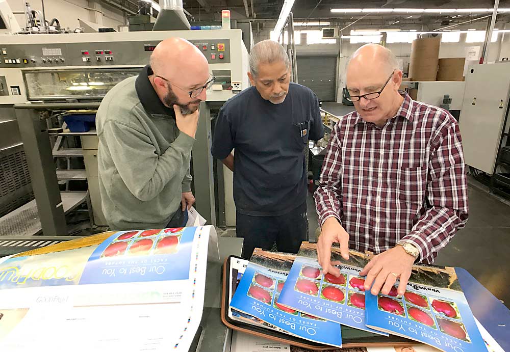 Good Fruit Grower magazine’s Doug Button, right, and Jared Johnson, left, review copies of the magazine fresh off the printer in Seattle, Washington, in October 2017. (TJ Mullinax/Good Fruit Grower)
