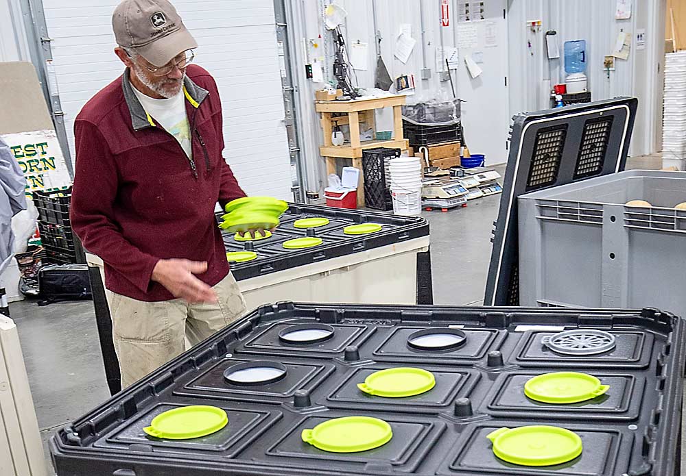 Michael King says he follows Janny’s recommendations for how many membrane lids to remove to adjust the gas exchange rates to optimize for each crop and storage timing, such as with his apples, where he keeps five out of nine lids on each bin at his regular atmosphere storage facility. (TJ Mullinax/Good Fruit Grower)