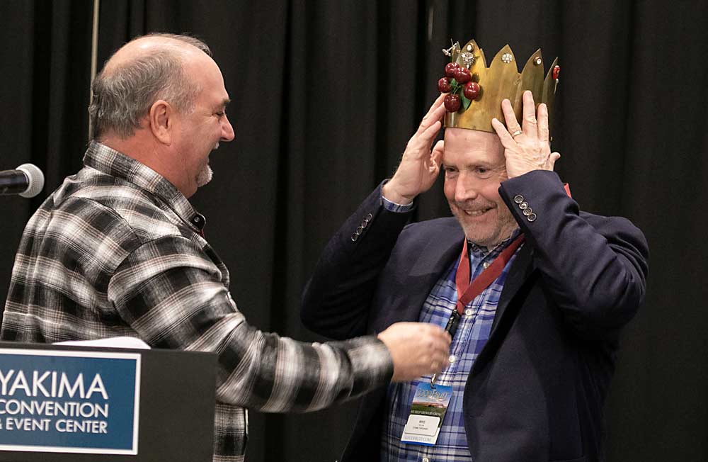 Mike Taylor of Stemilt Growers accepts the Cherry King crown from last year’s winner, Pat Sullivan. (TJ Mullinax/Good Fruit Grower)