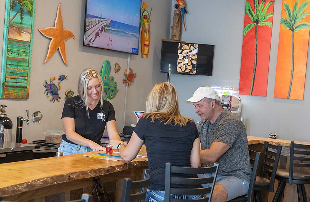 Winery co-owner Ashley Nitz behind the bar at Chill Hill in downtown Baroda, Michigan. The location has adequate room for indoor gatherings, but the Nitz family wants more space to host outdoor events. (Matt Milkovich/Good Fruit Grower)