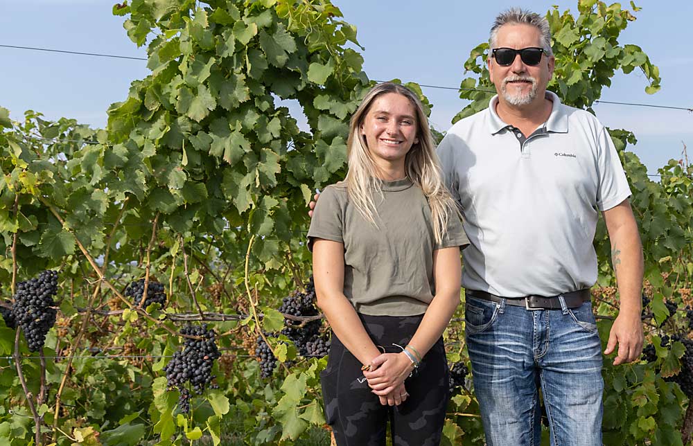 Katelynn and Dan Nitz in front of a row of Garnacha, the Spanish name for Grenache grapes. Katelynn plans to join the family business when she’s done with college. (Matt Milkovich/Good Fruit Grower)