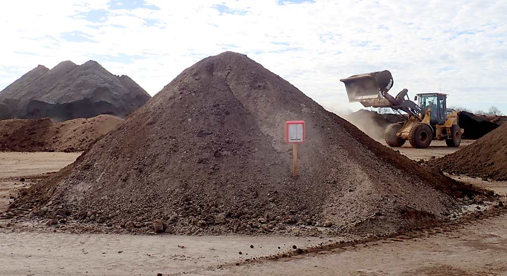 Loaders, dump trucks and conveyors at Morgan Composting Inc. in Sears, Michigan, are in constant motion converting piles of fresh manure into compost. The company is especially well-known for its Dairy Doo brand. (Leslie Mertz/for Good Fruit Grower)