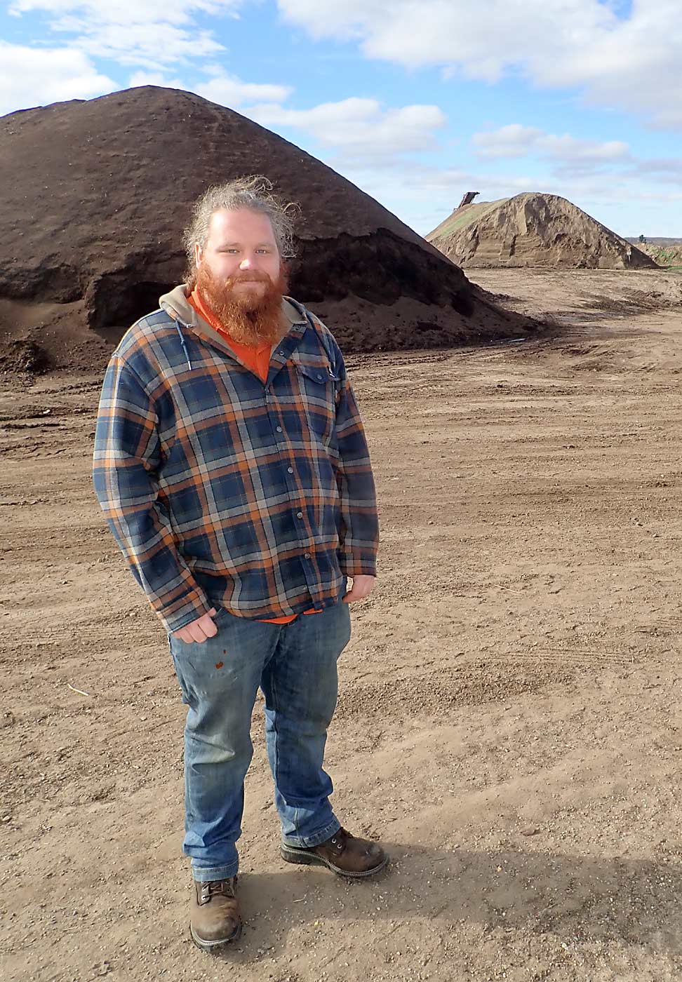 Agronomist Theo Medendorp poses at Morgan Composting. Manure goes through a months-long process to become compost at the facility. That includes turning the material and monitoring the temperature, which helps ensure good activity of decomposers, he said. (Leslie Mertz/for Good Fruit Grower)