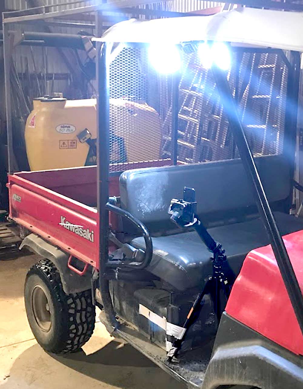 In the Cornell trials, lights are hung from the ATV to illuminate the vineyard rows. The smartphone sits on a support called a gimbal that is attached to a tripod in front of the passenger seat. The Cornell team conducts night trials so the camera can better filter out background objects. (Courtesy Jonathan Jaramillo/Cornell University)