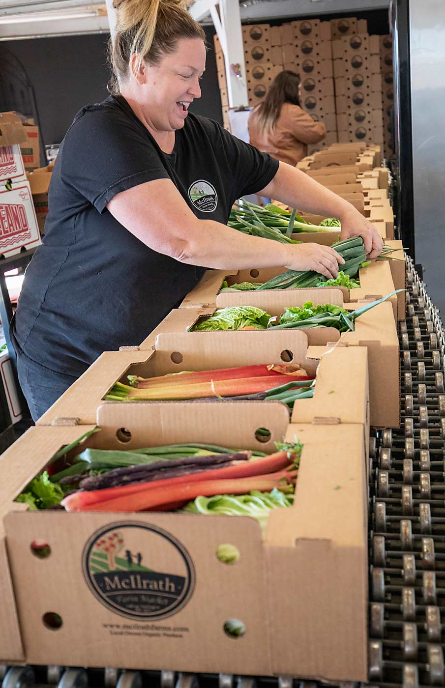 Laura McIlrath-Riel fills produce boxes with a wide variety of local and uncommon fruits and vegetables for delivery and pickup. She partners with a dozen local farms to supply the produce. (TJ Mullinax/Good Fruit Grower)
