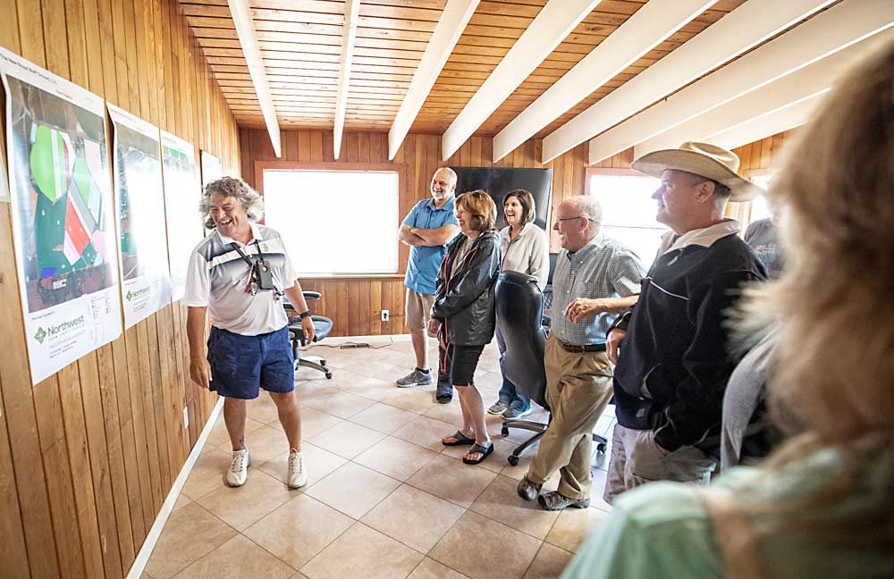 Craver talks with investors during an August 2018 tour of their current and future blocks at the office of New Royal Bluff Orchards. Craver is a managing partner in that company but also serves as a management consultant for other area farms. (TJ Mullinax/Good Fruit Grower)
