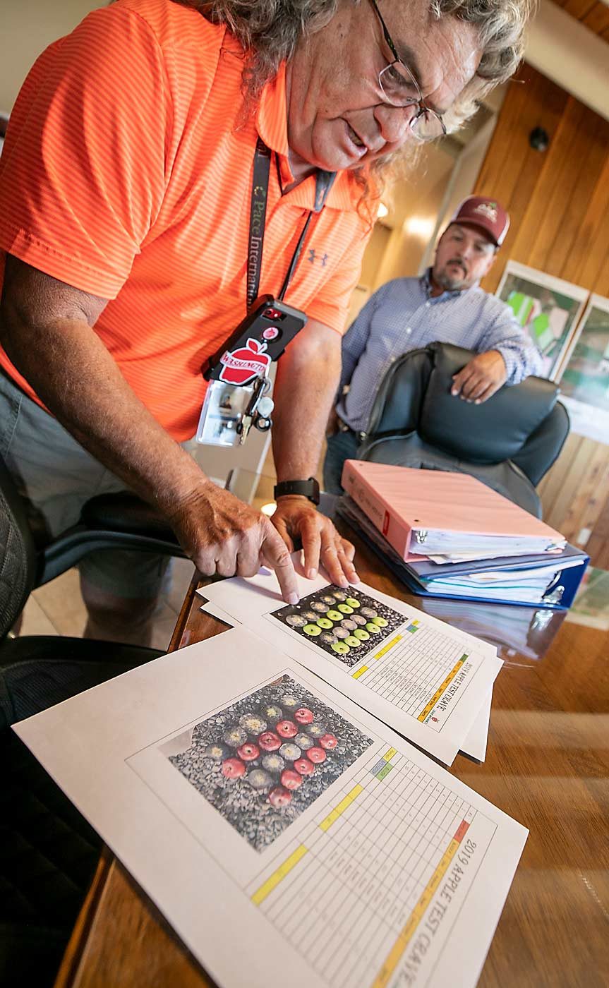 Craver goes over starch scales with Manuel Martinez, a manager who has worked with Craver for 30 years, at the offices of New Royal Bluff Orchards. (TJ Mullinax/Good Fruit Grower)