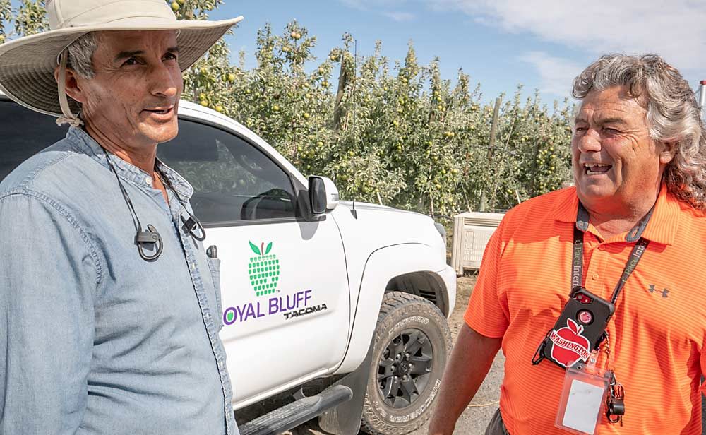 Craver discusses harvest with Juan Ojeda, a farm manager and one of his many longtime employees, at New Royal Bluff Orchards. The two have worked together for 22 years. (TJ Mullinax/Good Fruit Grower)