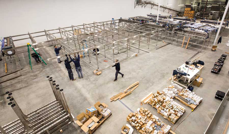Workers install a cherry processing line that will feature optical equipment to sort fruit at The Dalles Fruit Co. in Dallesport, Washington, on January 13, 2016. (TJ Mullinax/Good Fruit Grower)