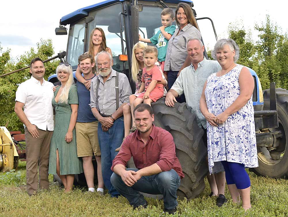 Four generations of the Day family on their farm in Kelowna, BC.  Left to right: Joshua Holland, Kati Day-Holland, Riley Johnson, Erin Day-Johnson, Ernie Day, Sam Fincham, Lily Avery, Jackson Fincham, Kolton Fincham, Tracy Avery Day, Kevin Day and Karen Day.  Kati worked with the BC Investment Agriculture Foundation to help the family install a high-tech pear packing line on their farm in 2019. 
