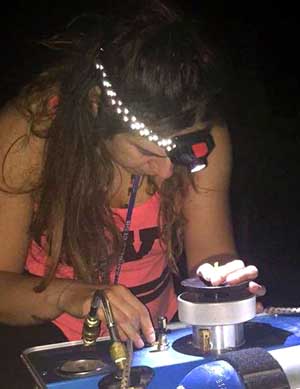 Washington State University researcher Joelle Martinez uses a pressure bomb to measure predawn leaf water potential in the summer of 2018 in the university’s Roza research vineyard near Prosser. Martinez has concluded that varieties fall on a spectrum with regard to how much they will respond to water stress. (Courtesy Joelle Martinez)
