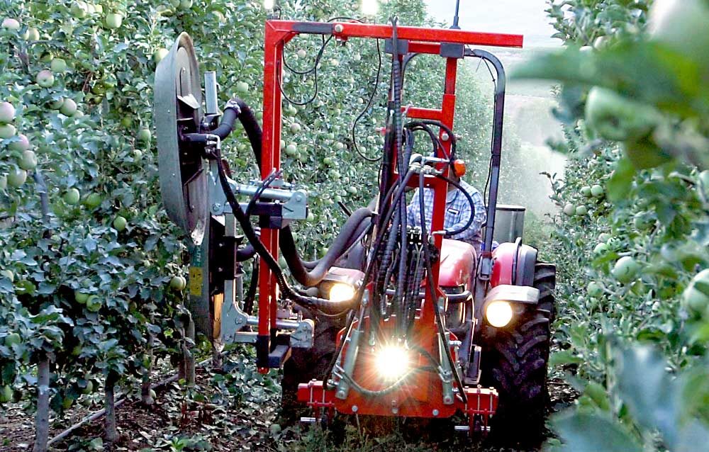 The Olmi 501 F pneumatic defoliator blows off leaves in a Cripps Pink block at Gebbers Farms in Okanogan County, Washington, in September. Growers who tested the machine this year are excited about the performance and plan to buy more, said Greg Hamilton of MGH Equipment, who imported the Italian-built machines. (Courtesy Washington Tractor)