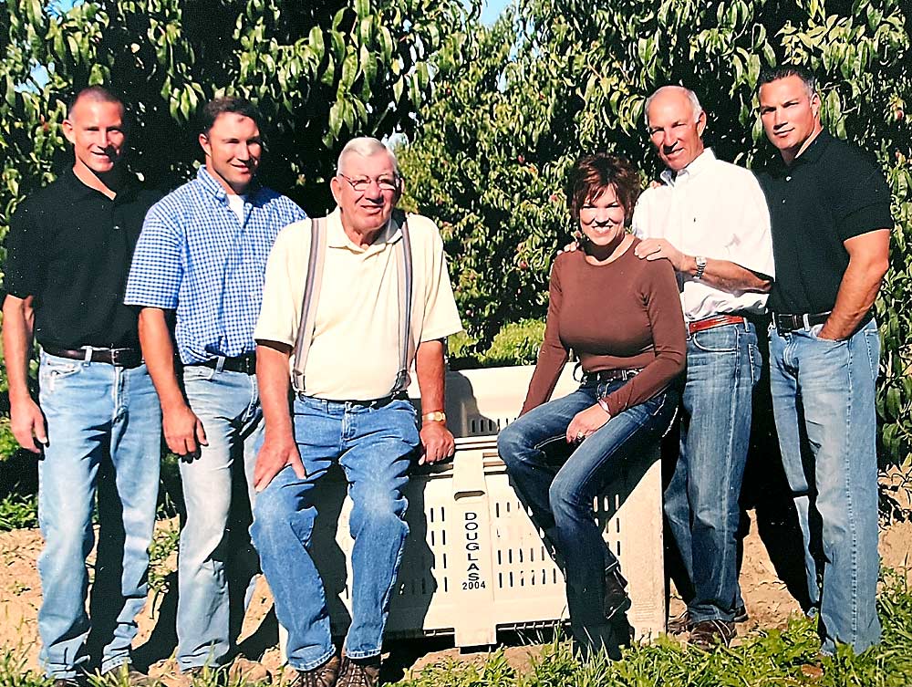 The Douglas family stuck with stone fruit, embraced the organic opportunity early and built a fruit business known for its focus on quality, earning them the honor of being the 2023 Good Fruit Growers of the Year. From left: David, John, “Big John,” Jill, Bill and Pete Douglas in a family photo from 2011. Holly Douglas Wilson had retired a few years prior. (Courtesy Douglas Family)