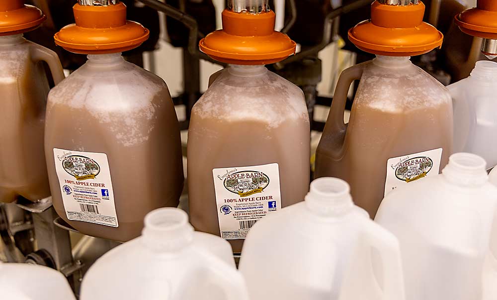 Plastic jugs are filled with cider at the Engelsma’s Apple Barn cider mill in September. The family has won the annual Michigan Apple Cider Contest a record eight times. (Matt Milkovich/Good Fruit Grower)
