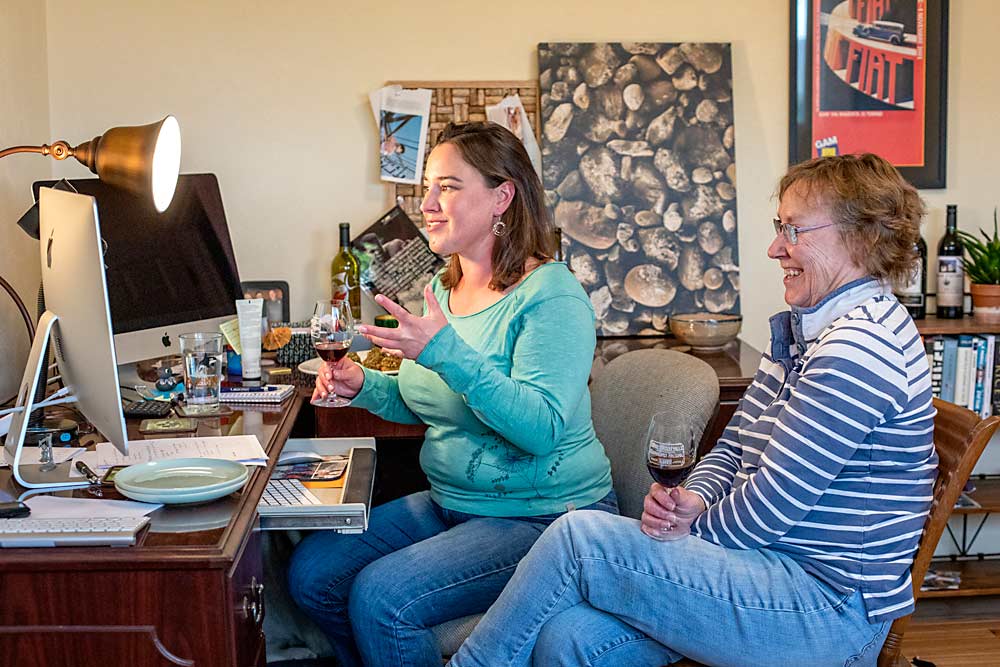 Kerry, left, and Kathy Shiels greet viewers of their “Virtual Happy Hour” at Kerry’s home in Sunnyside, Washington, in April. Kerry is the winemaker for Côte Bonneville winery and her parents, Kathy and Hugh Shiels (not pictured), established DuBrul Vineyard in the Yakima Valley American Viticultural Area in 1992. (TJ Mullinax/Good Fruit Grower)