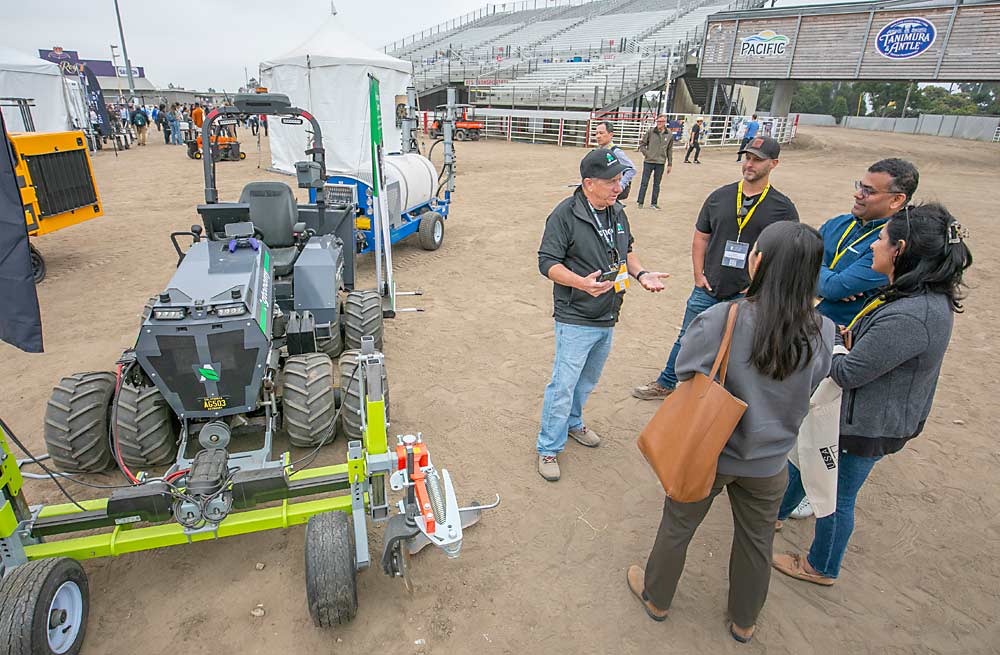 Tim Bucher, CEO and founder of Agtonomy, explains his company’s self-driving tractor and software package to spectators at the 2023 FIRA USA specialty crop automation conference and trade show in September at the Salinas Sports Complex in Salinas, California. (TJ Mullinax/Good Fruit Grower)