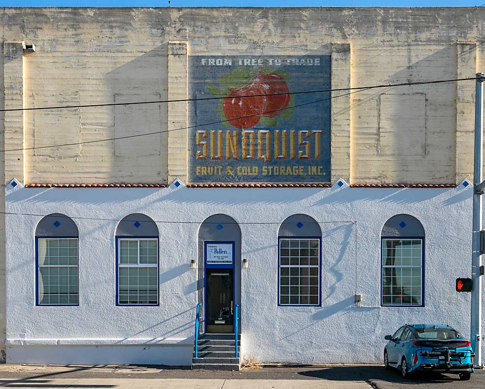 A painting of a Sundquist Fruit and Cold Storage box label remains bright and colorful on the American Fruit Growers warehouse and former Sundquist packing house office in Yakima, Washington. It is now the office, laboratory and drying facility for Firman Pollen along Fruit Row. (TJ Mullinax/Good Fruit Grower)