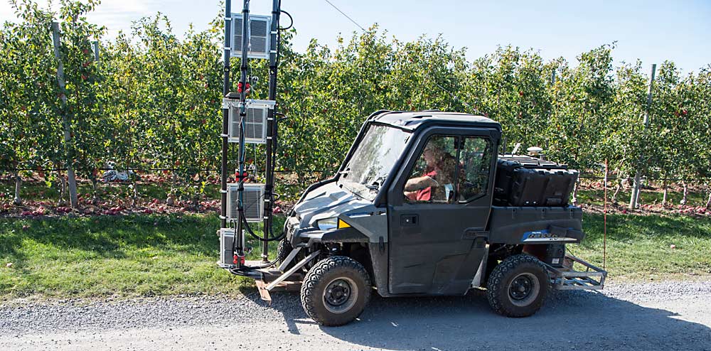 The Moog apple data rover uses towers of lights and cameras, which will eventually be mounted on an automated platform, to assess crop load on a per-tree basis throughout the season, according to Chris Layer, principal engineer for the New York-based engineering firm. (Amanda Morrison/for Good Fruit Grower)