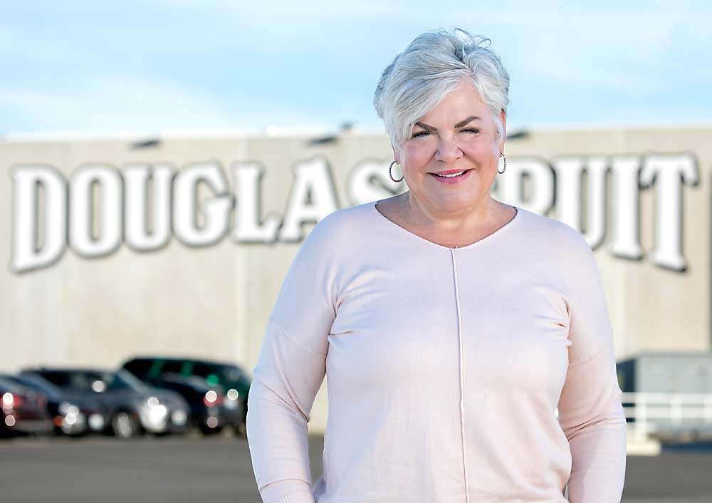 Holly Wilson stands outside the Douglas Fruit facilities in Pasco. Though she retired from her role with the company 17 years ago, the company still relies on many of the same customer relationships she built. (TJ Mullinax/Good Fruit Grower)