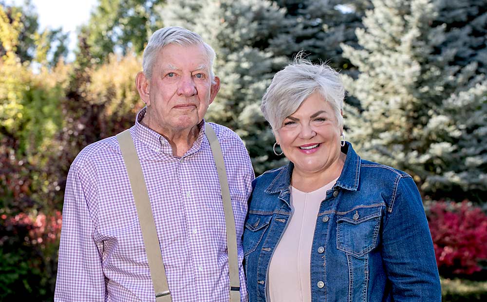 Grower “Big John” Douglas and his daughter, Holly Douglas Wilson, the longtime sales lead at Douglas Fruit, both now retired from the family company, pictured together in September. (TJ Mullinax/Good Fruit Grower)
