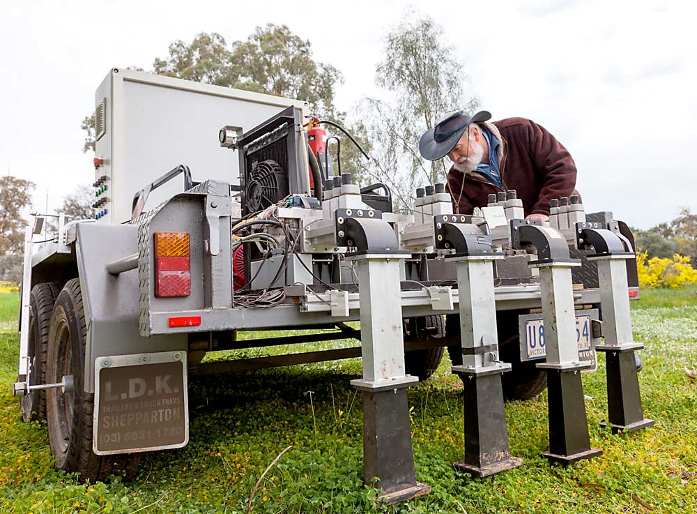 University of Melbourne engineering professor Graham Brodie with the microwave weed-killing machine he invented. (Courtesy Ian Crick/University of Melbourne)