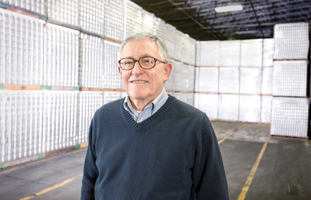 Jay Grandy, manager of the Washington-Oregon Canning Pear Association for nearly two decades, will retire in 2015. Grandy stands in part of the Del Monte, canning facility in Yakima, Washington, surrounded by cans ready for use in processing apples and pears on March 23, 2015. (TJ Mullinax/Good Fruit Grower)