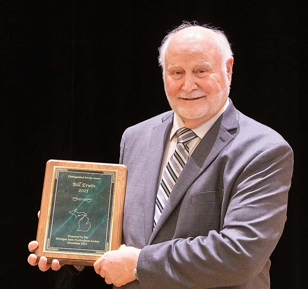Bill Erwin receives the Distinguished Service Award from the Michigan State Horticultural Society at the 2023 Great Lakes Fruit, Vegetable and Farm Market EXPO banquet Dec. 6. (Matt Milkovich/Good Fruit Grower)