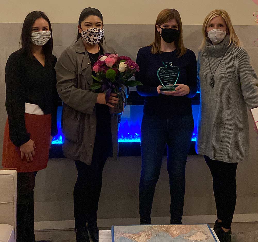 Anika Grubbs receives the Washington Apple Education Foundation 2020 Alumni Volunteer of the Year Award. Pictured left to right are Erika Betancourt, WAEF scholarship coordinator; Xochitl Velazquez, WAEF assistant director; Grubbs and Jennifer Witherbee, WAEF executive director. (Courtesy WAEF)