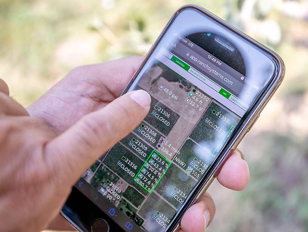 Edgar Escobar shows how the Ranch Systems app keeps him up to date on water applications, though none were scheduled as the irrigation water ran out a few weeks before harvest. (TJ Mullinax/Good Fruit Grower)