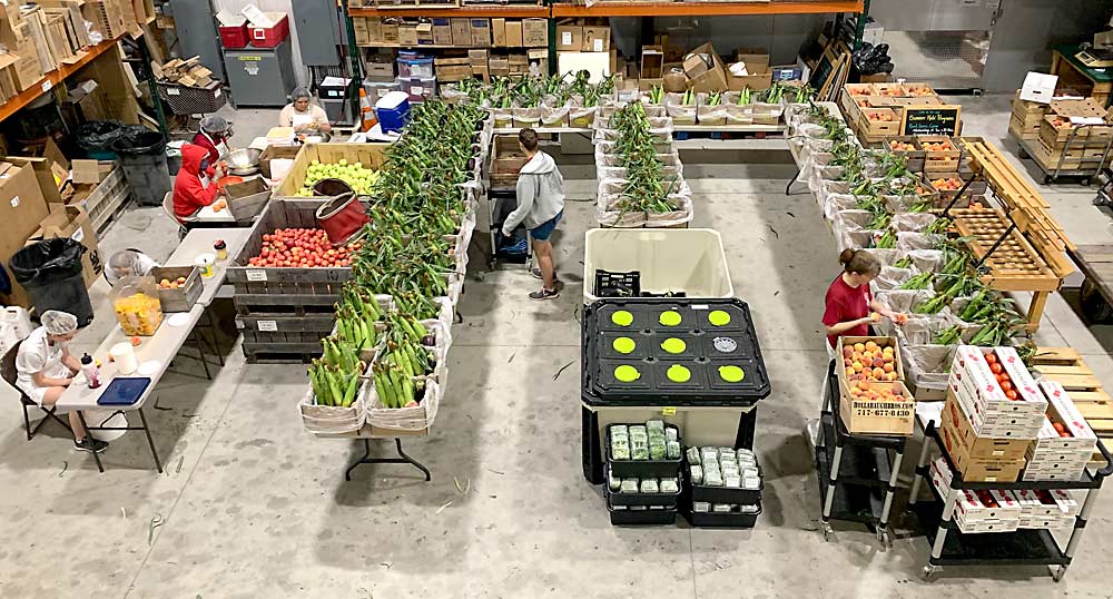 Packing CSA boxes at Hollabaugh Bros. in Biglerville, Pennsylvania, last August. The CSA serves about 150 customers nearly year-round. (Courtesy Hollabaugh Bros.)