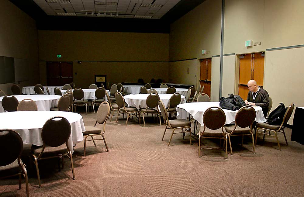 Industry groups are making contingency plans to move annual events online, even for activities months away, such as the Washington State Tree Fruit Association annual meeting, currently scheduled for December in Kennewick. In this file photo, Washington State University’s Stefano Musacchi prepares his presentation in a quiet room during some downtime at the 2014 annual meeting in Kennewick. (TJ Mullinax/Good Fruit Grower)